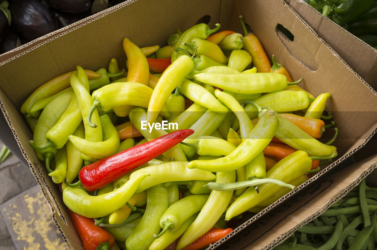 High angle view of jalapeno peppers in cardboard box for sale at market