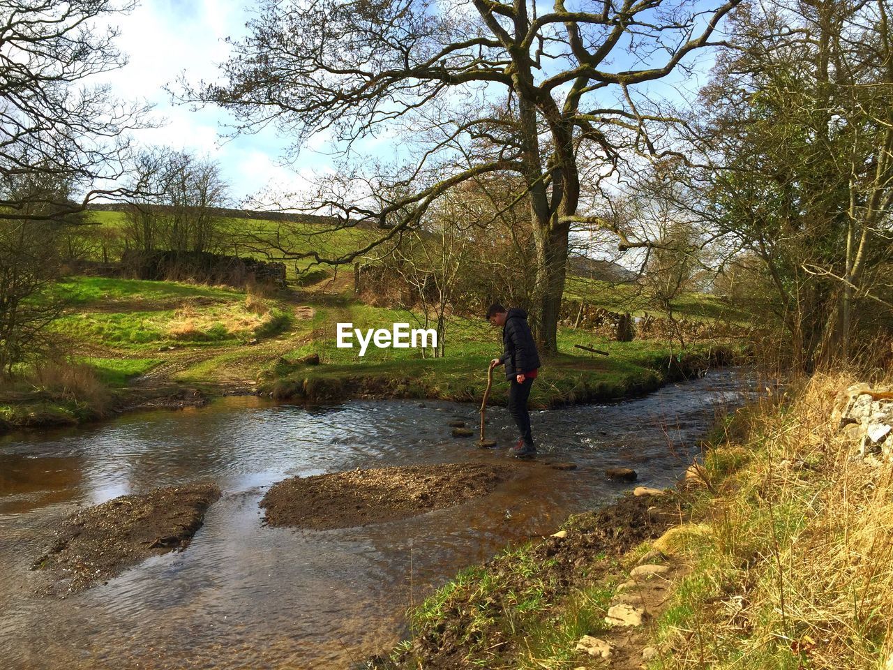 LOW SECTION OF MAN IN PUDDLE