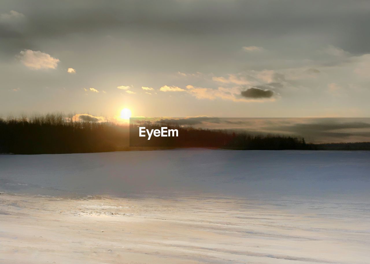 SCENIC VIEW OF FROZEN LAKE AGAINST SKY DURING WINTER