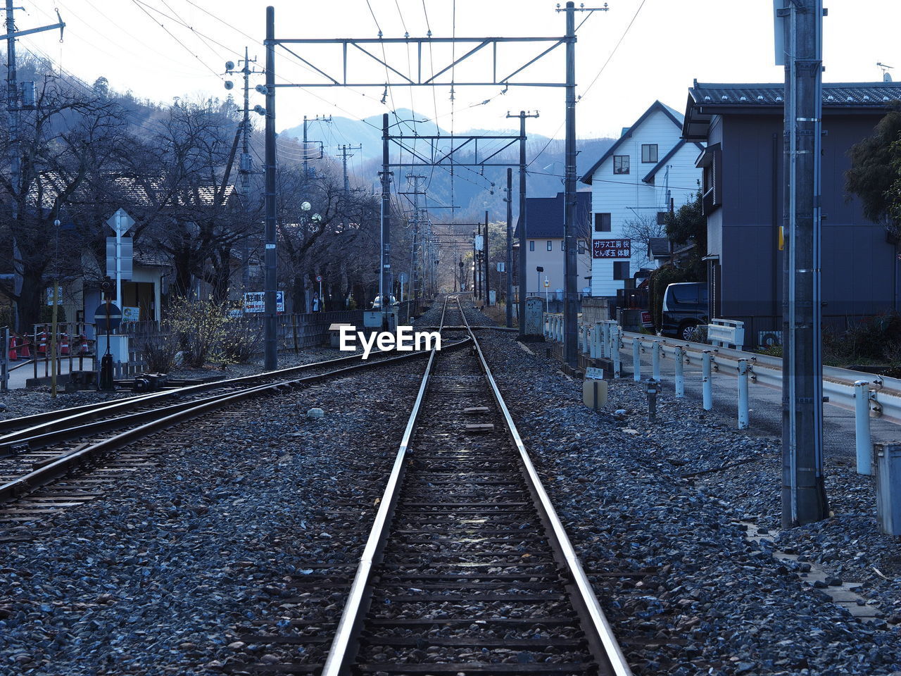 RAILROAD TRACKS WITH CITY IN BACKGROUND