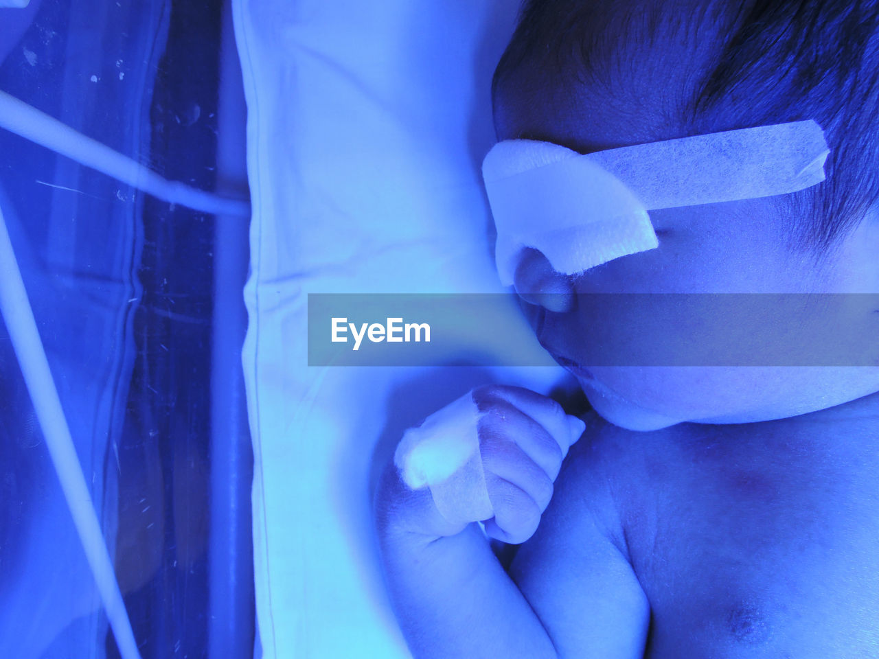 Close-up of baby in newborn care unit