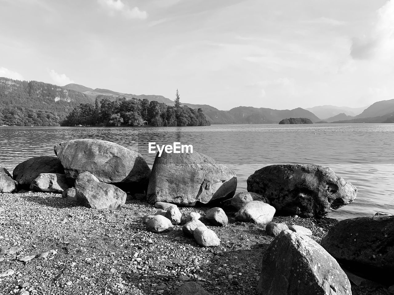 ROCKS ON SHORE AGAINST SKY