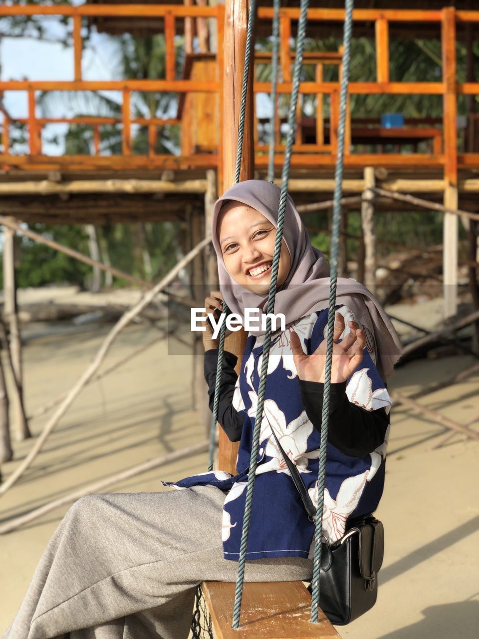 Portrait of smiling young woman standing outdoors