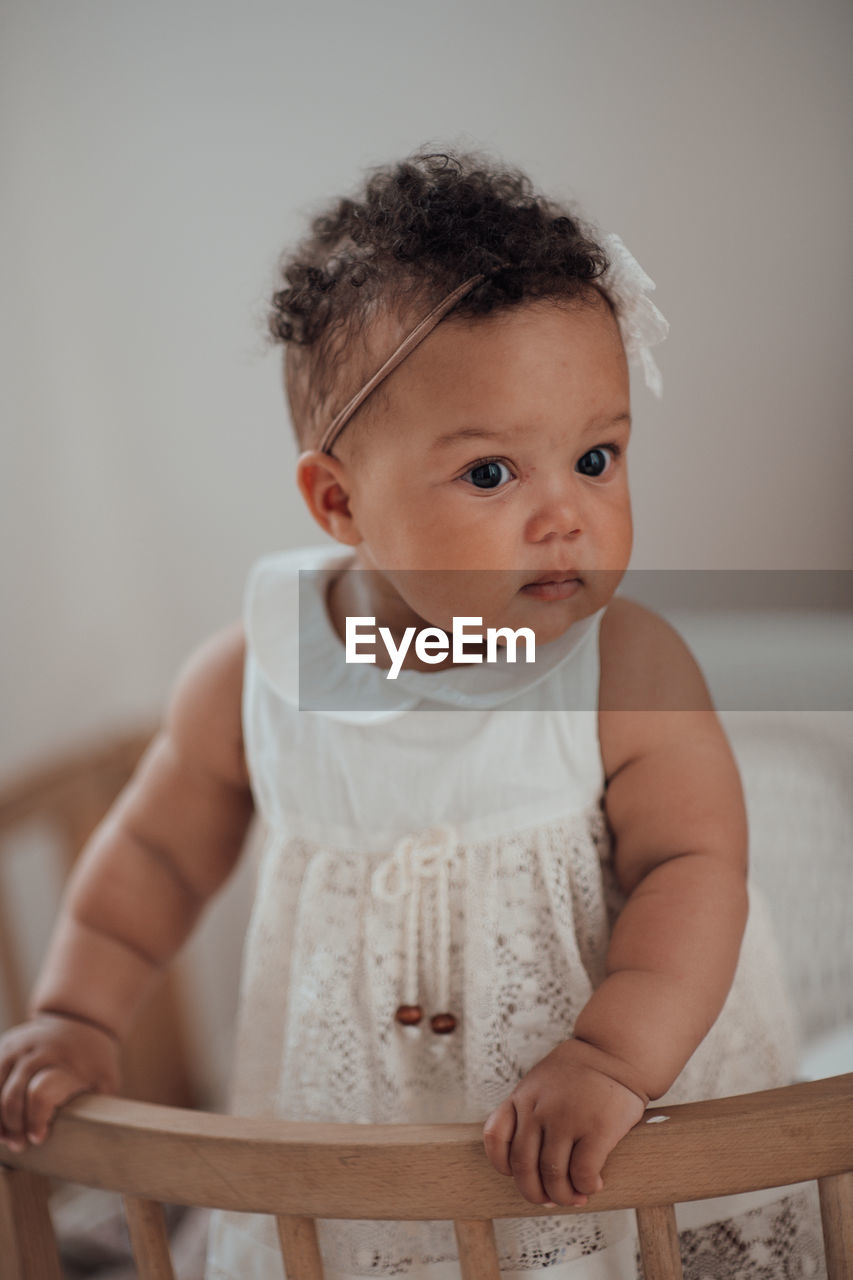 Portrait of cute baby girl at home