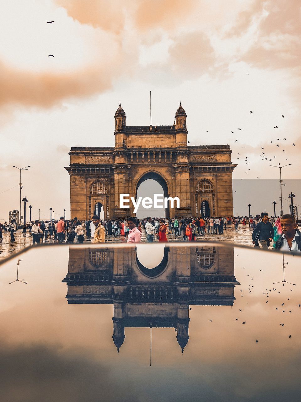 GROUP OF PEOPLE IN FRONT OF BUILDINGS