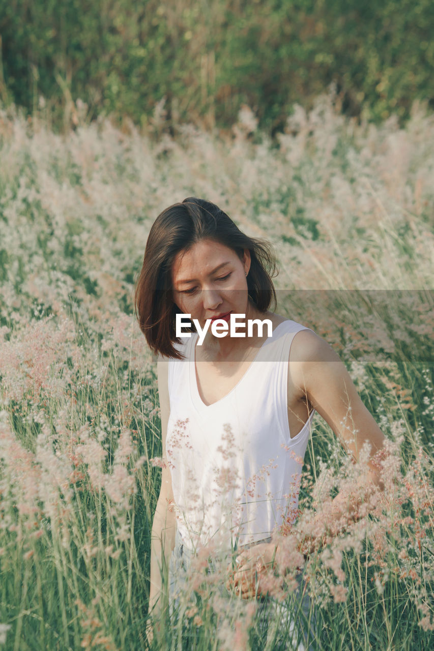 Woman standing amidst plants