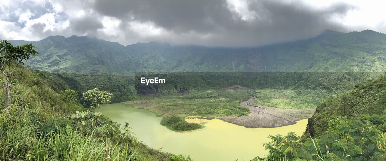 PANORAMIC SHOT OF LAND AND MOUNTAINS AGAINST SKY