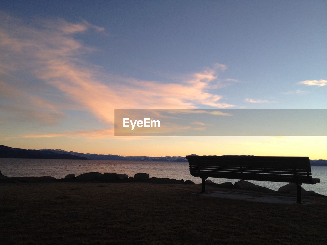 Bench on seaside at sunset