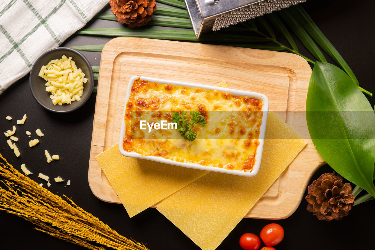 Directly above shot of lasagne in container on cutting board