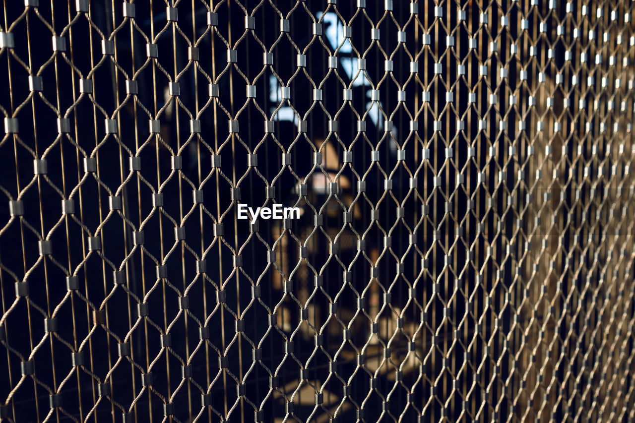 Full frame shot of chainlink fence at night