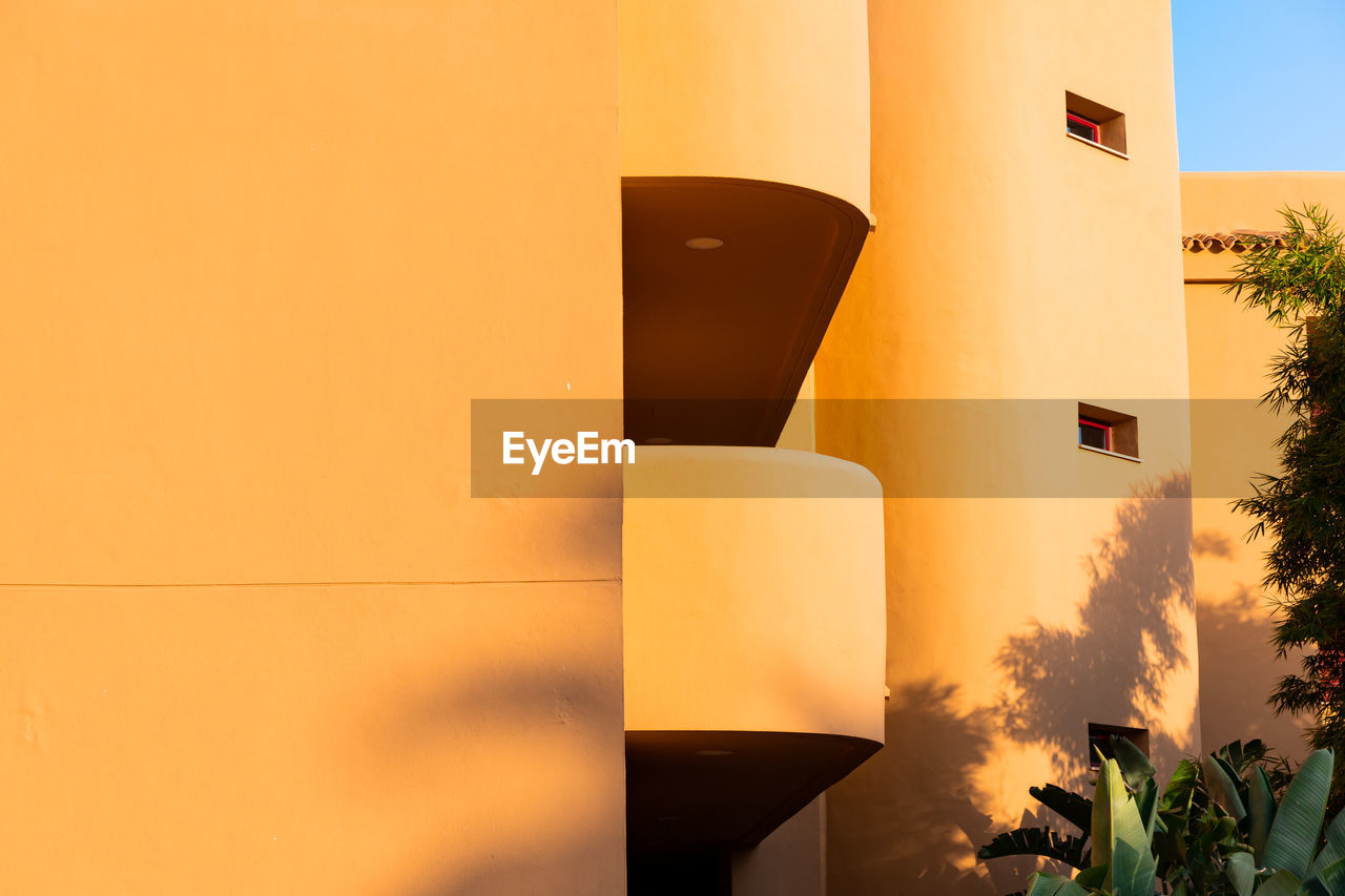 close-up of building against yellow wall