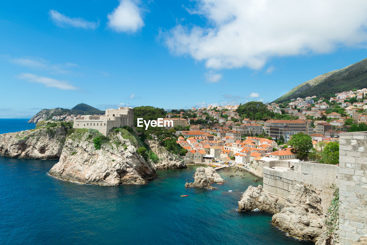 Fort lovrijenac by adriatic sea against cloudy sky