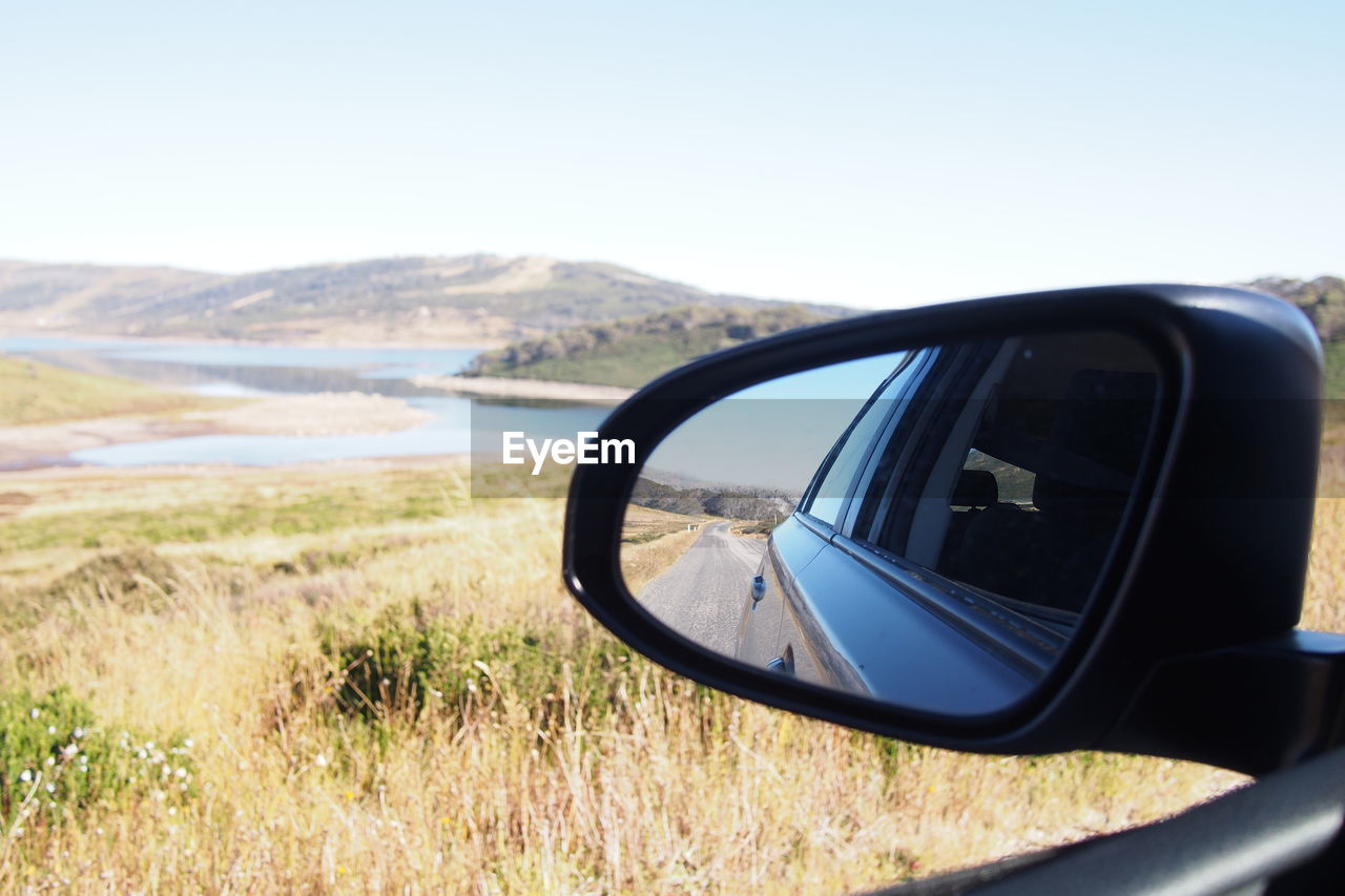 Car reflecting in side-view mirror