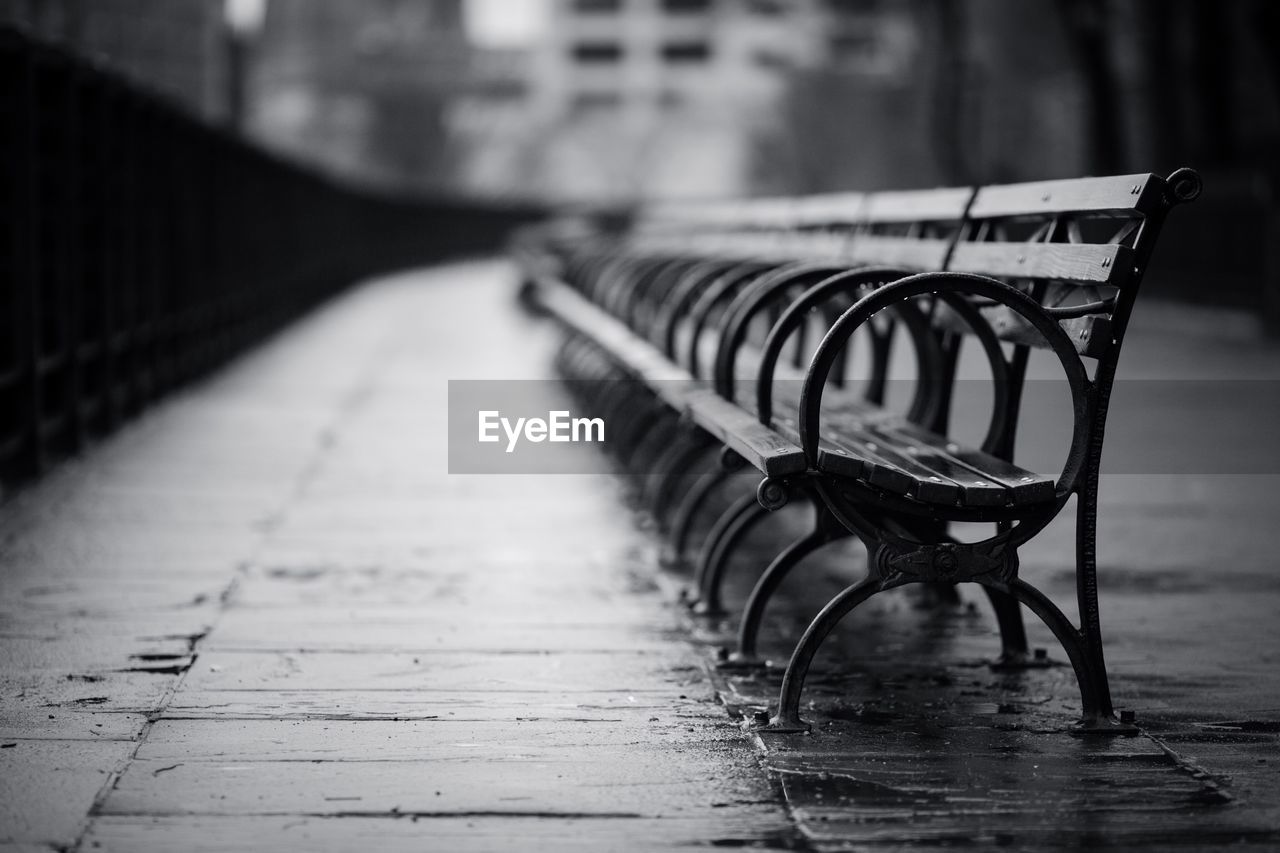 Empty benches on footpath