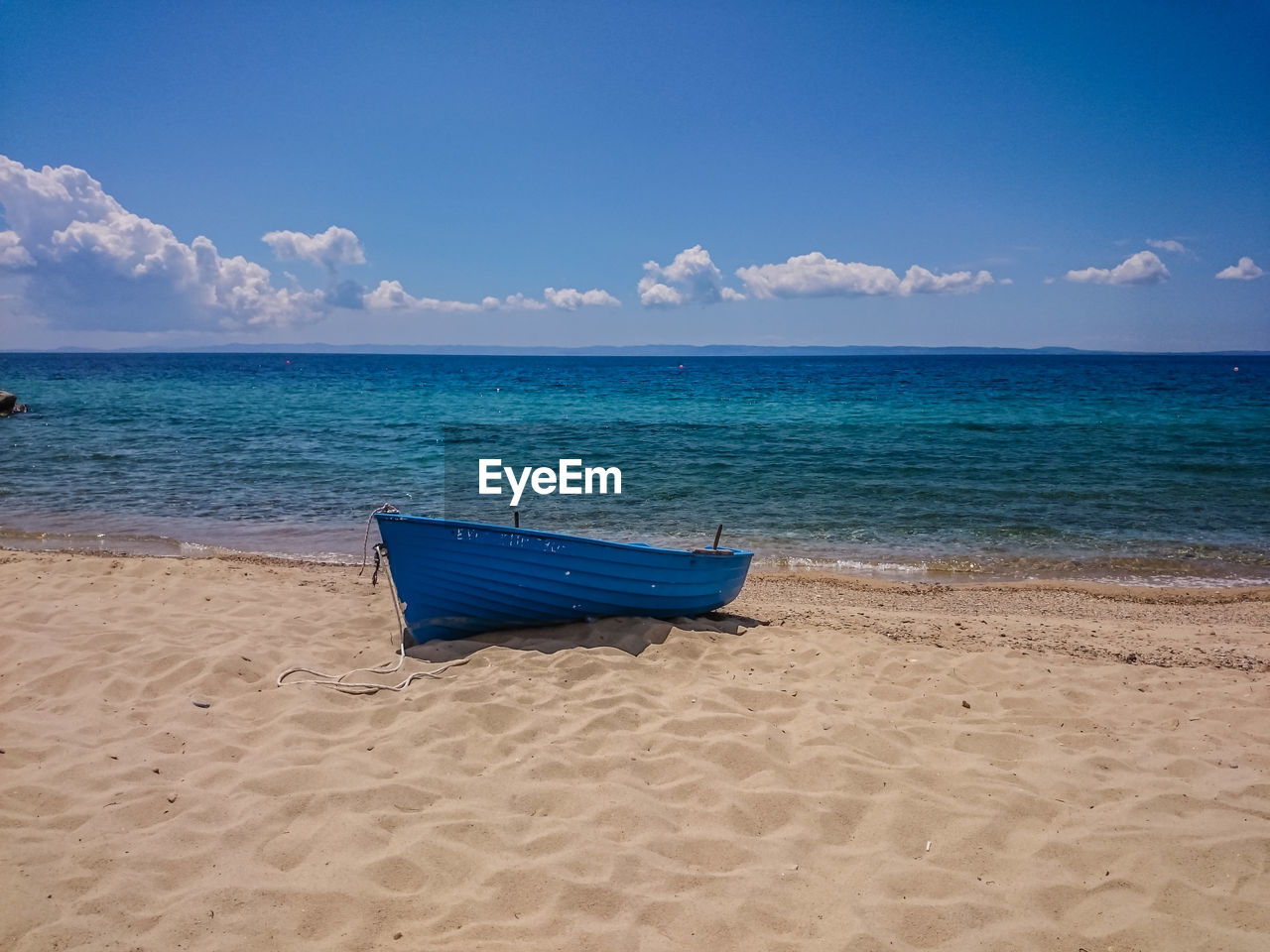 Scenic view of beach against blue sky