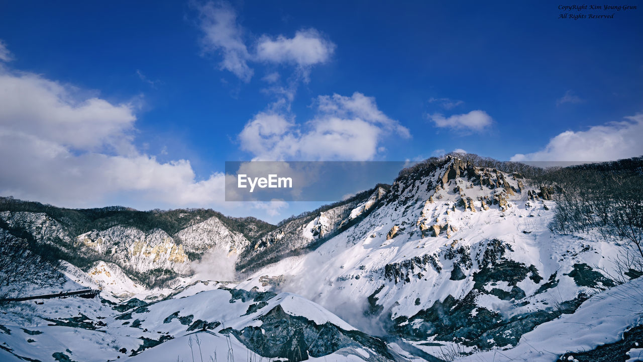 Scenic view of mountains against sky during winter