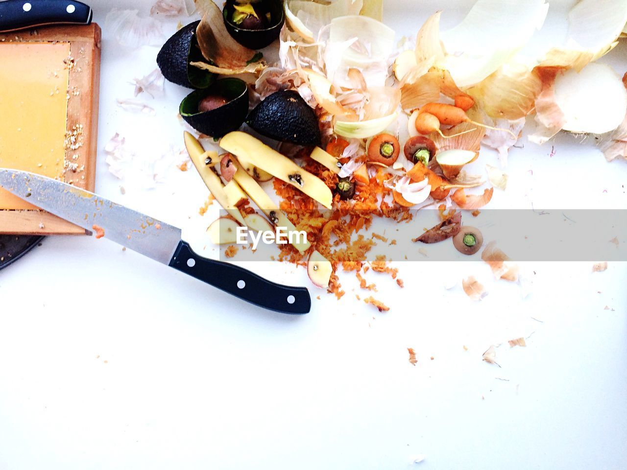 Elevated view of vegetable peelings and knife