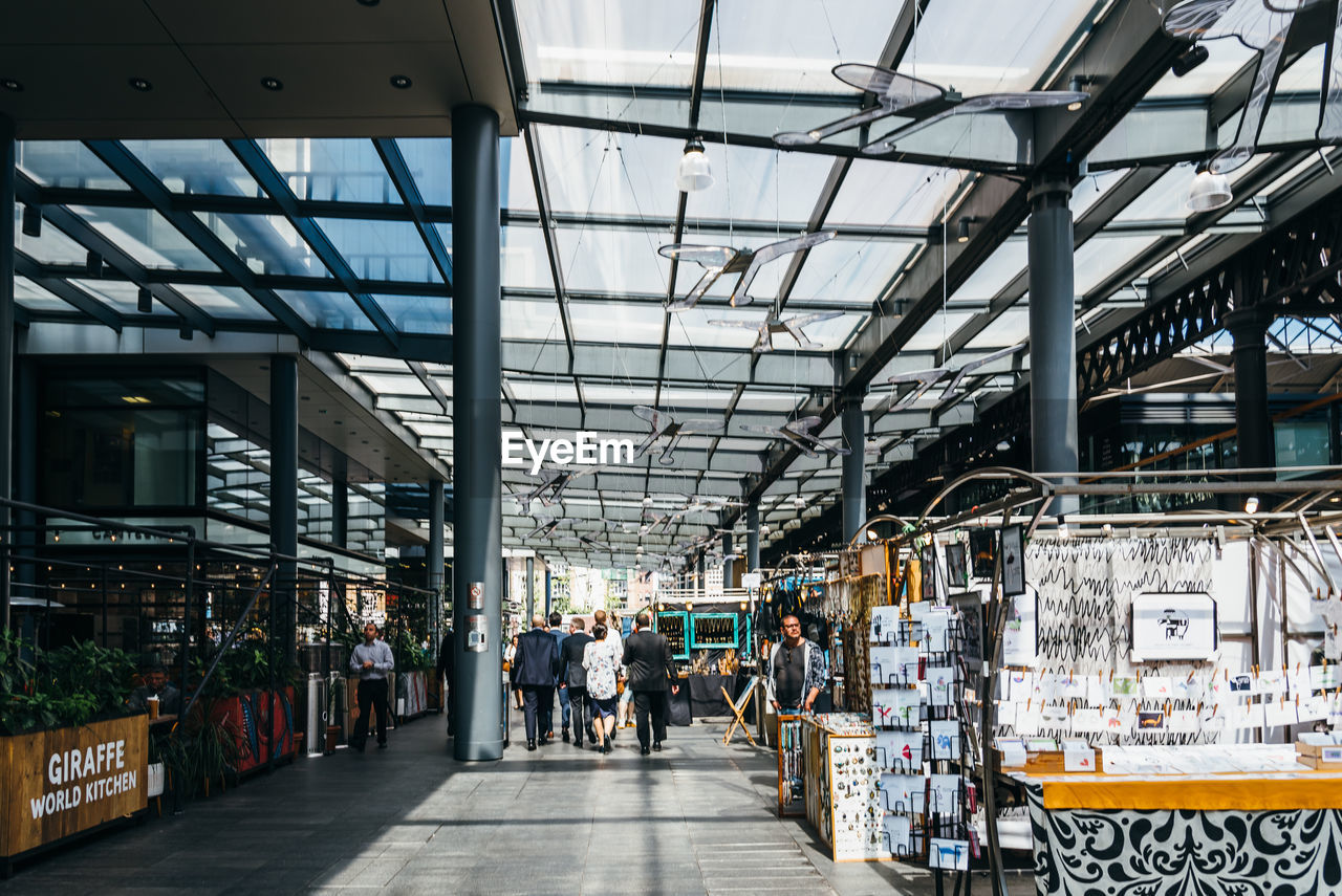 PEOPLE WALKING IN MARKET IN CITY