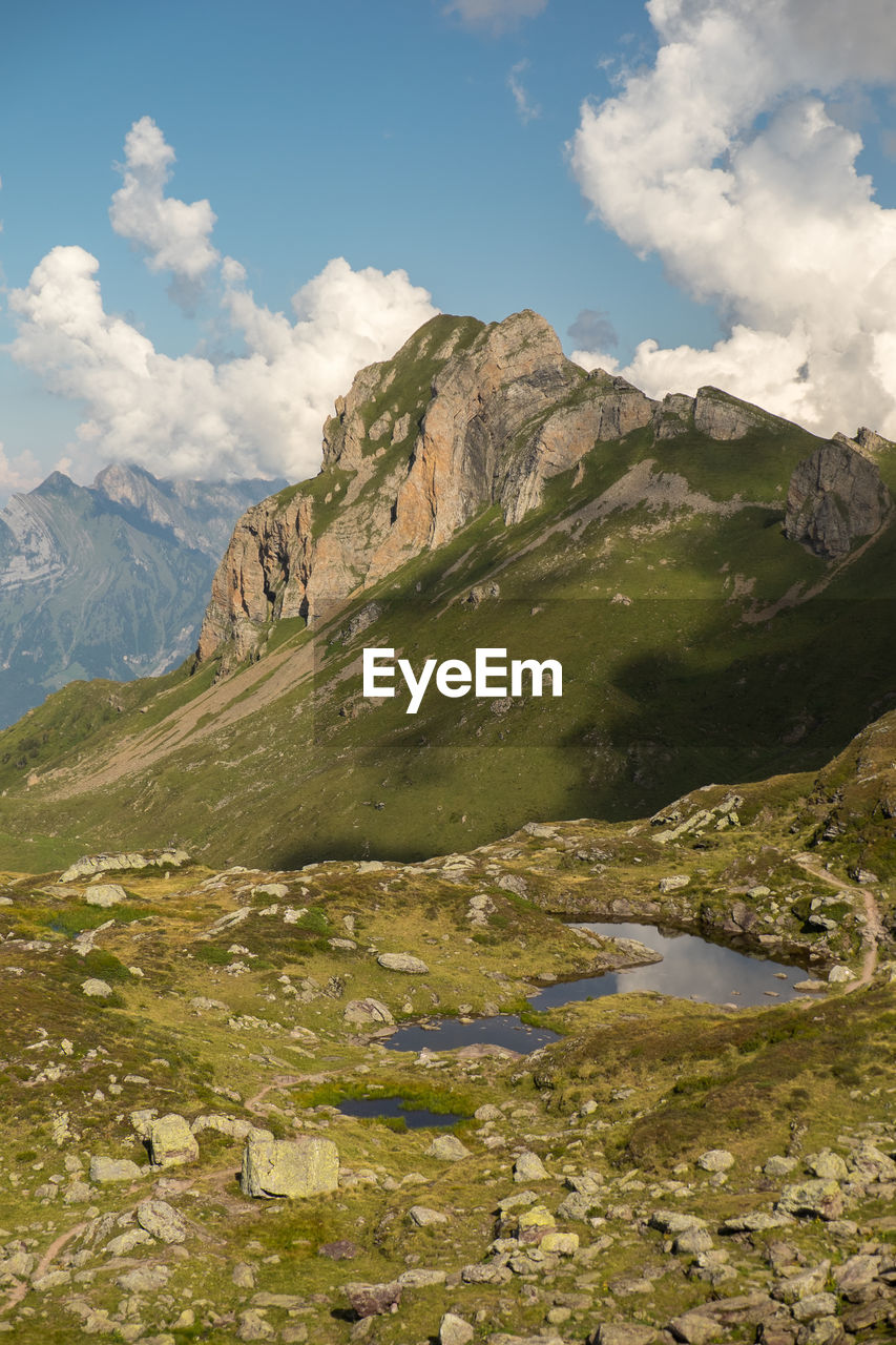 Scenic view of mountains against cloudy sky