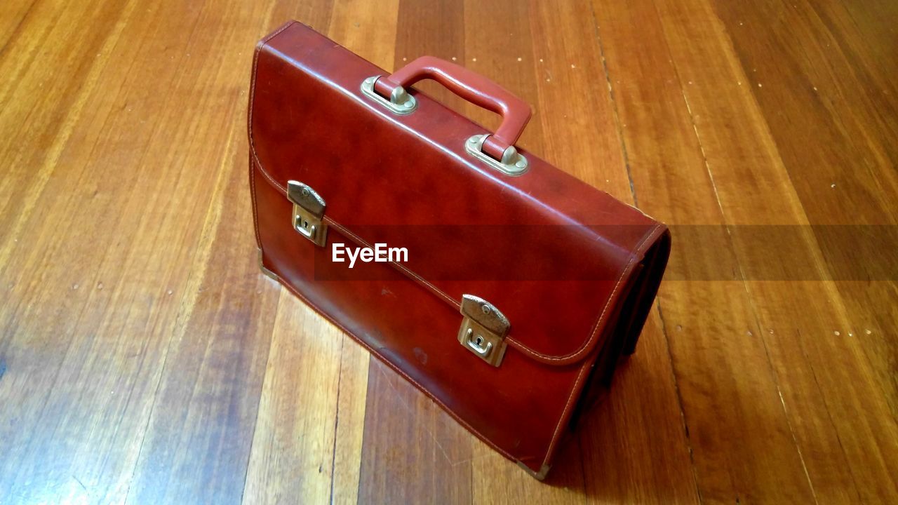 High angle view of briefcase on hardwood floor