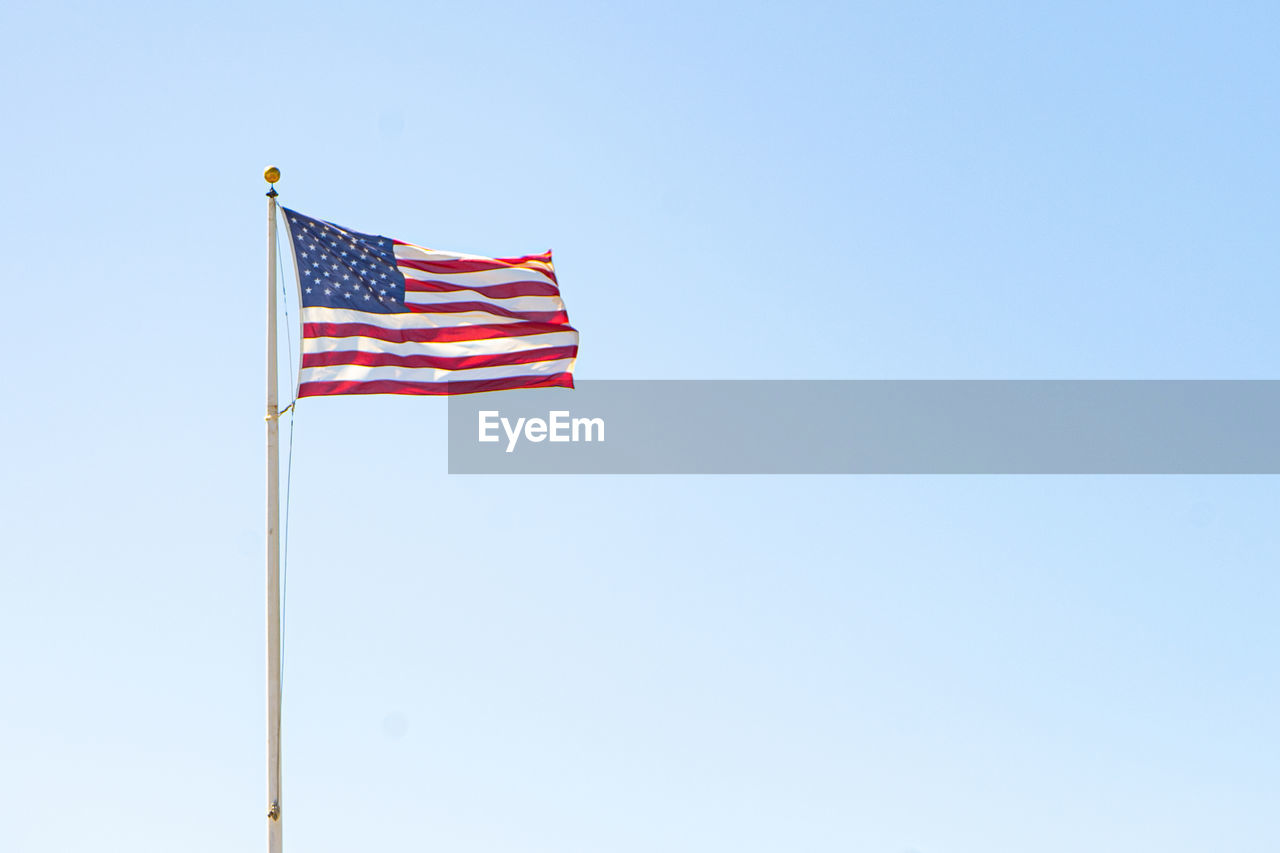 LOW ANGLE VIEW OF FLAGS FLAG AGAINST CLEAR SKY