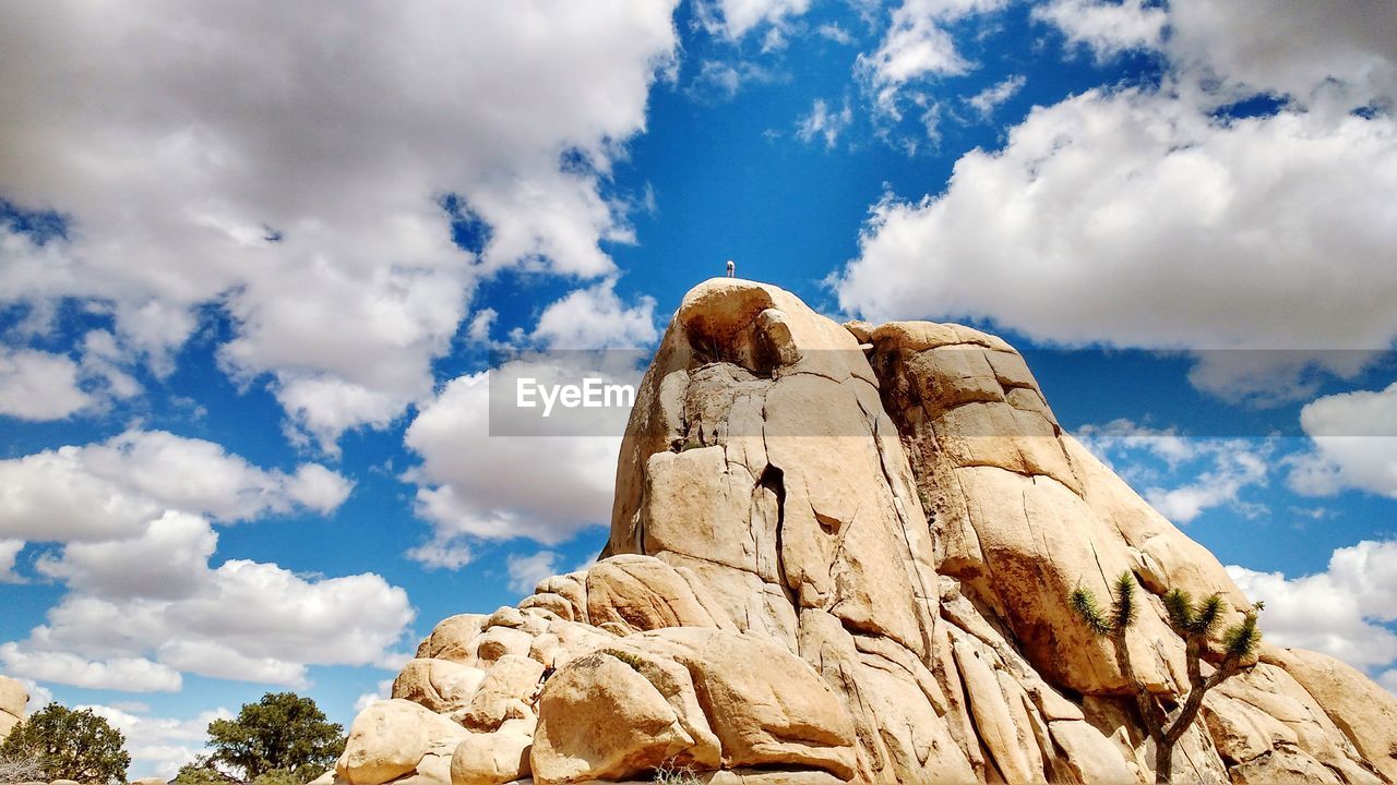 Low angle view of rock formations against blue sky at joshua tree national park