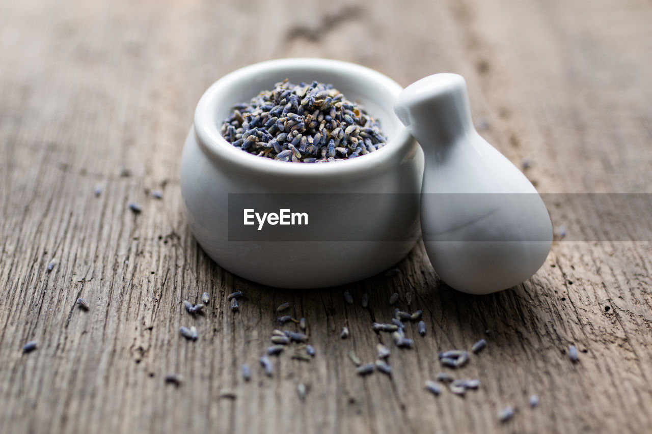 Close-up of dried lavender in mortar and pestle on table