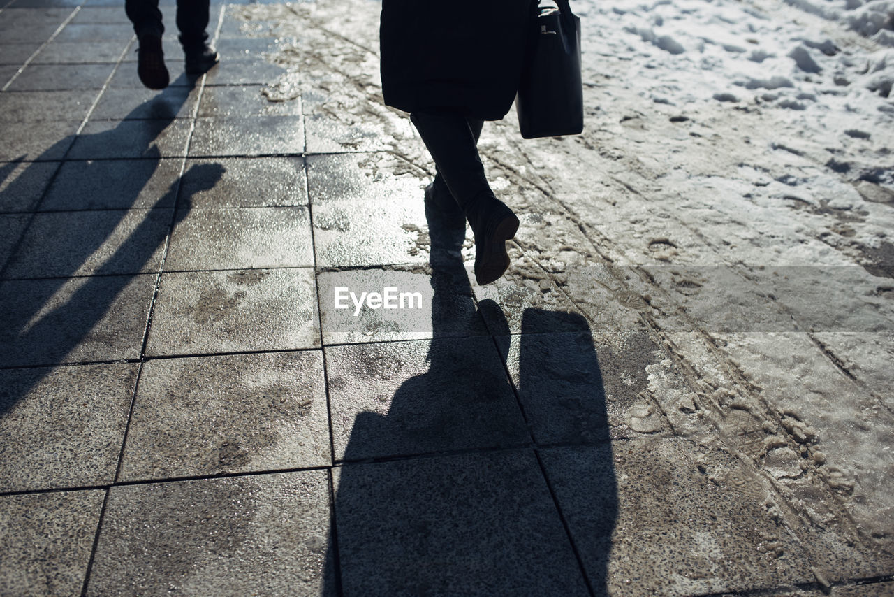 Low section of people walking on street