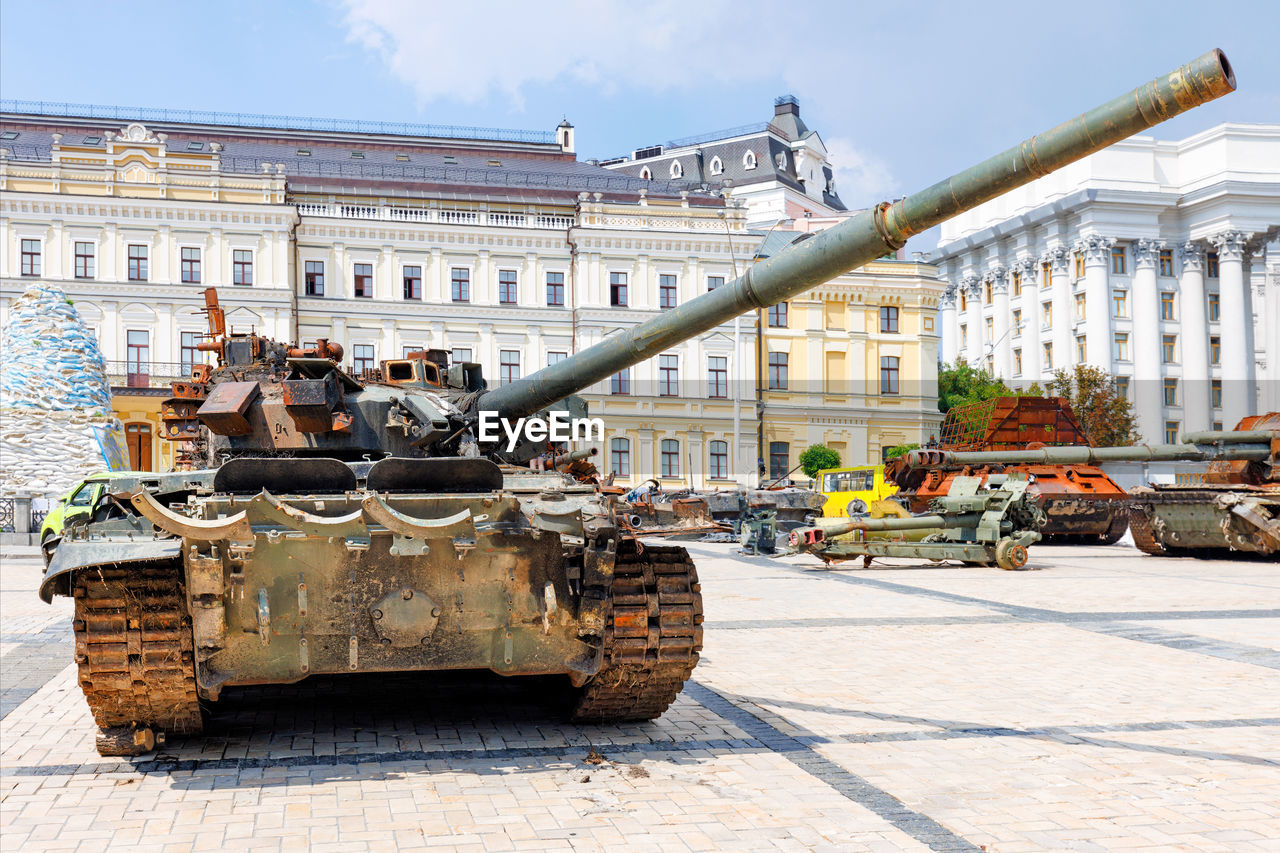 A destroyed rusty russian tank is put up for inspection in one of the central city squares of kyiv.