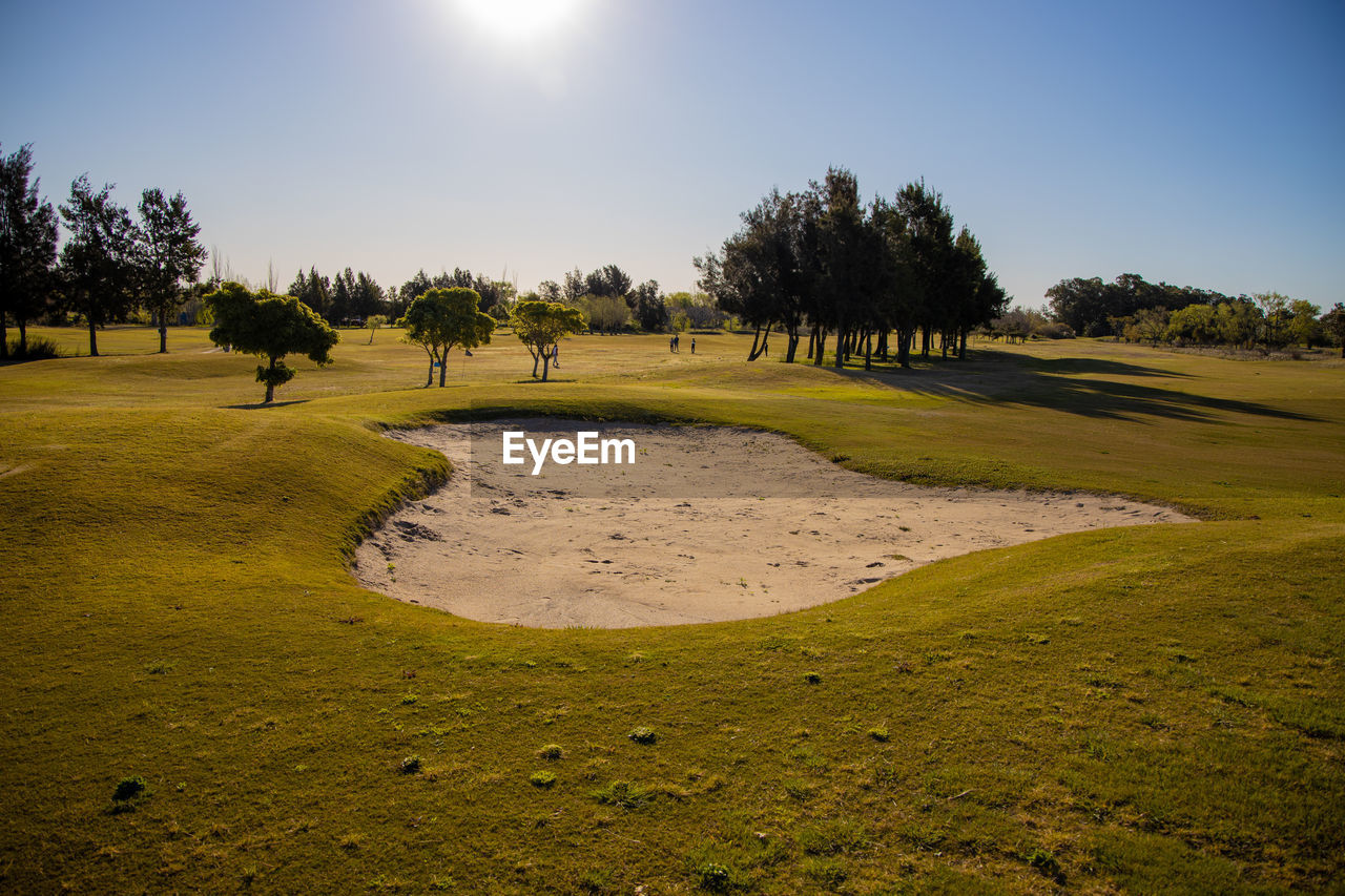 Scenic view of golf course against sky