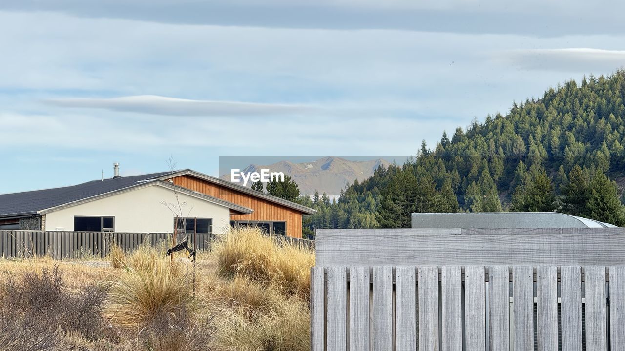 architecture, built structure, plant, cloud, sky, building exterior, house, building, nature, tree, land, no people, rural area, landscape, wood, scenics - nature, day, fence, mountain, residential district, outdoors, environment, non-urban scene, grass, hut, rural scene, beauty in nature, home, agricultural building