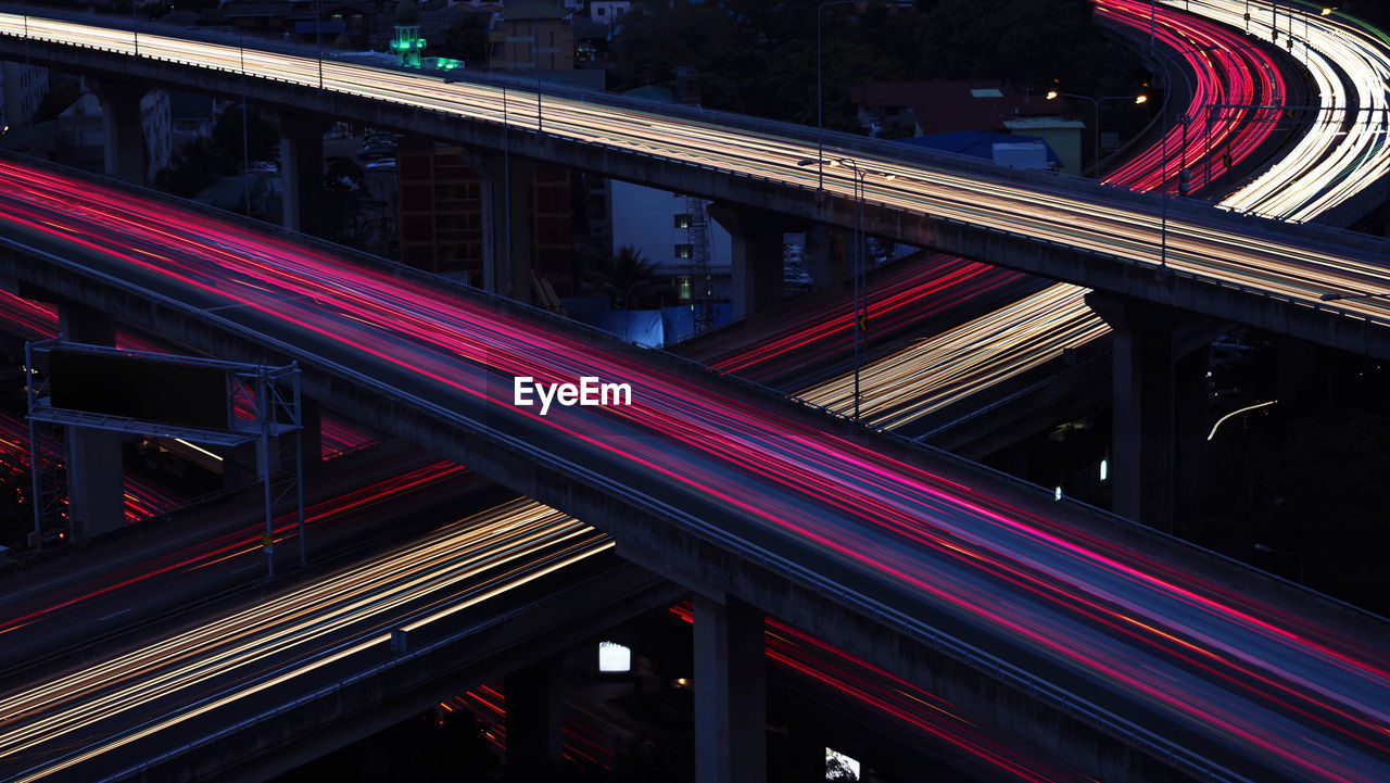 Motion blur of car light in city highway at dawn. cross intersection of urban highways.