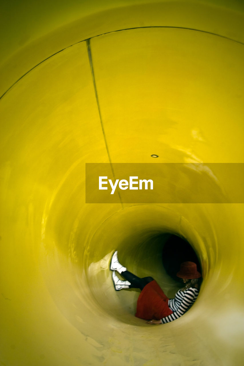 Woman resting in yellow slide