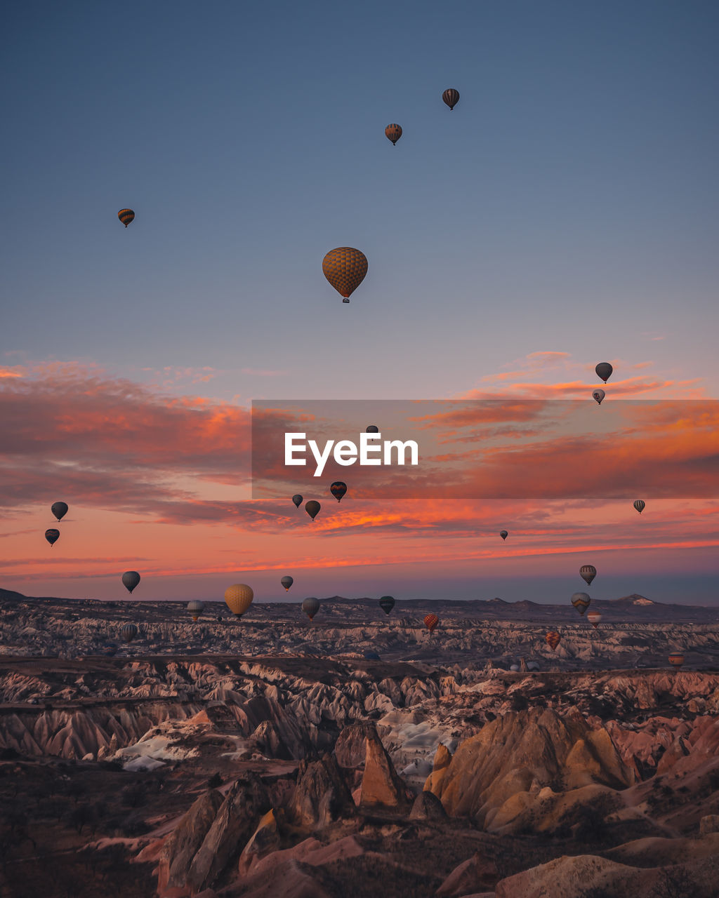 VIEW OF HOT AIR BALLOONS FLYING IN SKY AT SUNSET
