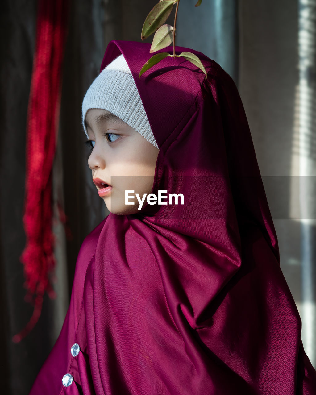 Portrait of a happy muslim toddler girl with hijab. natural light, selective focus.