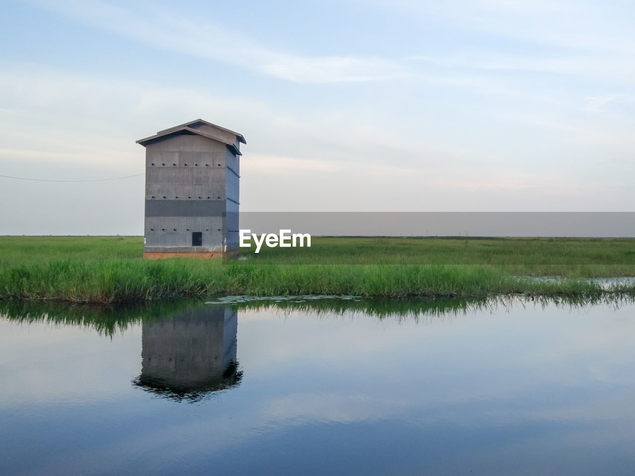 Scenic view of farm against sky