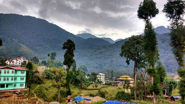 VIEW OF TOWN AGAINST CLOUDY SKY