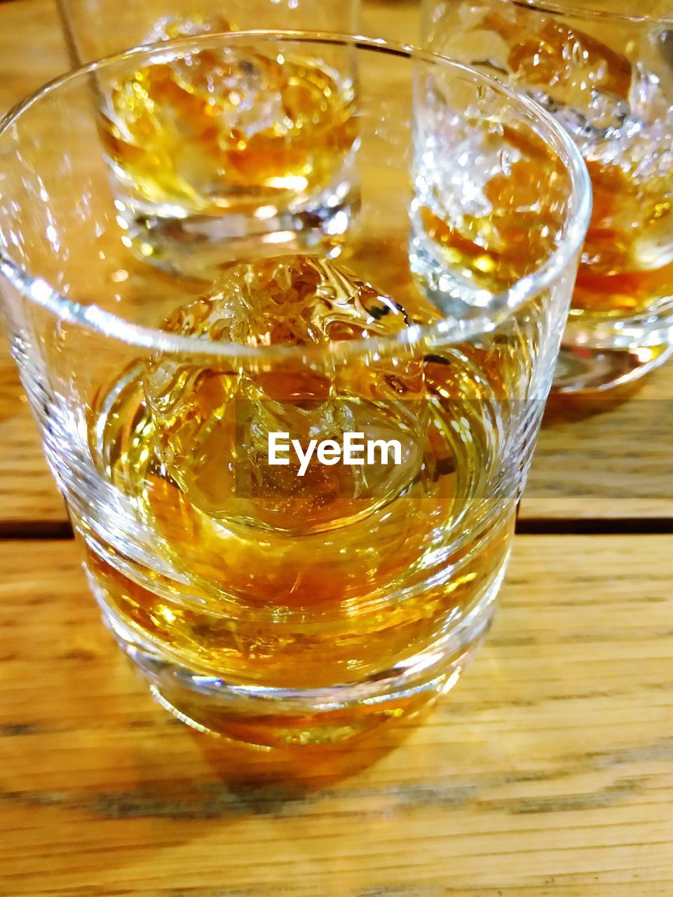 High angle view of whiskey on the rocks glasses on table