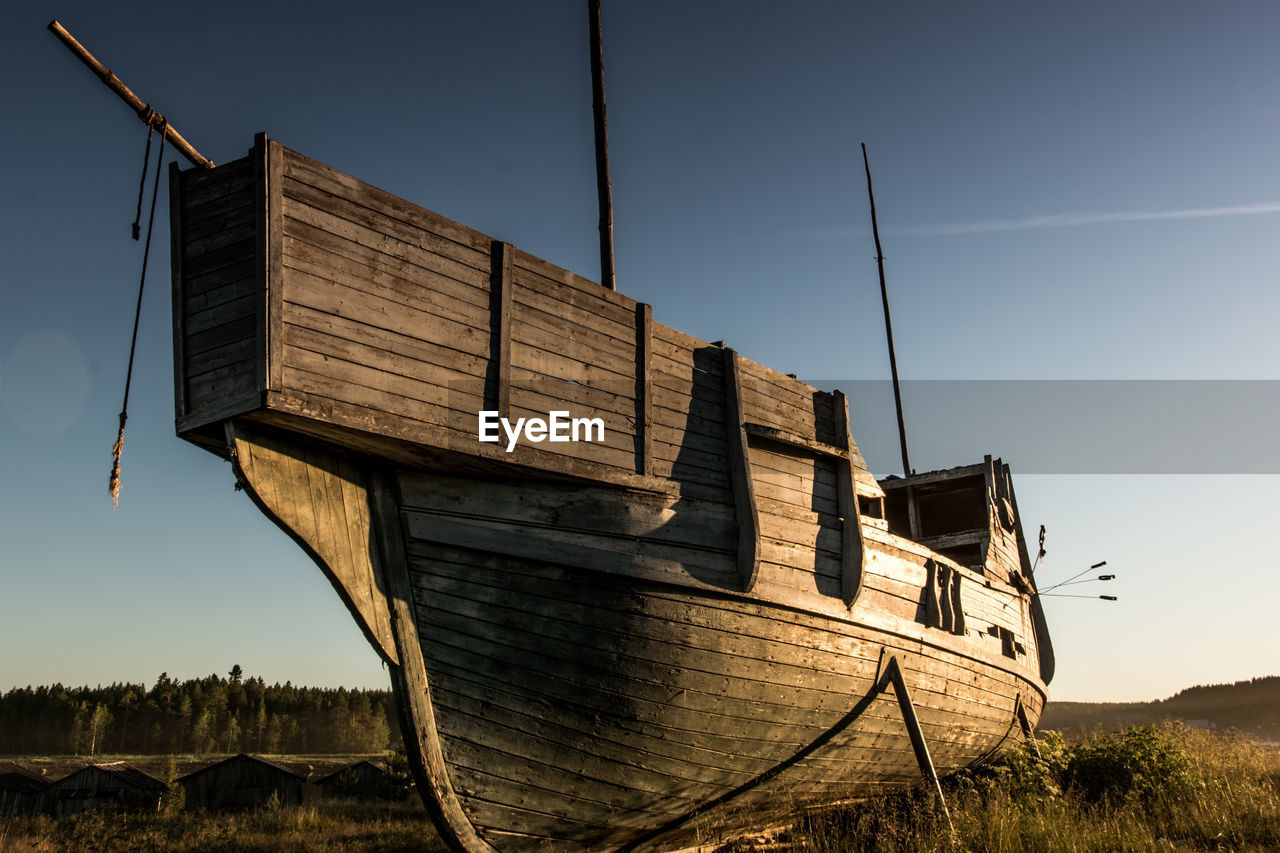 An old vikings boat staying on grass. russia, karelia. high quality photo