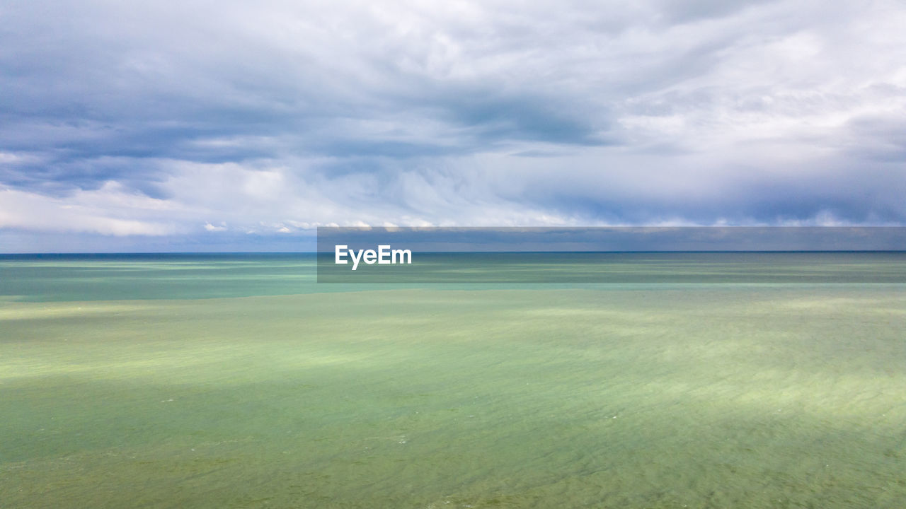 Scenic view of sea against cloudy sky