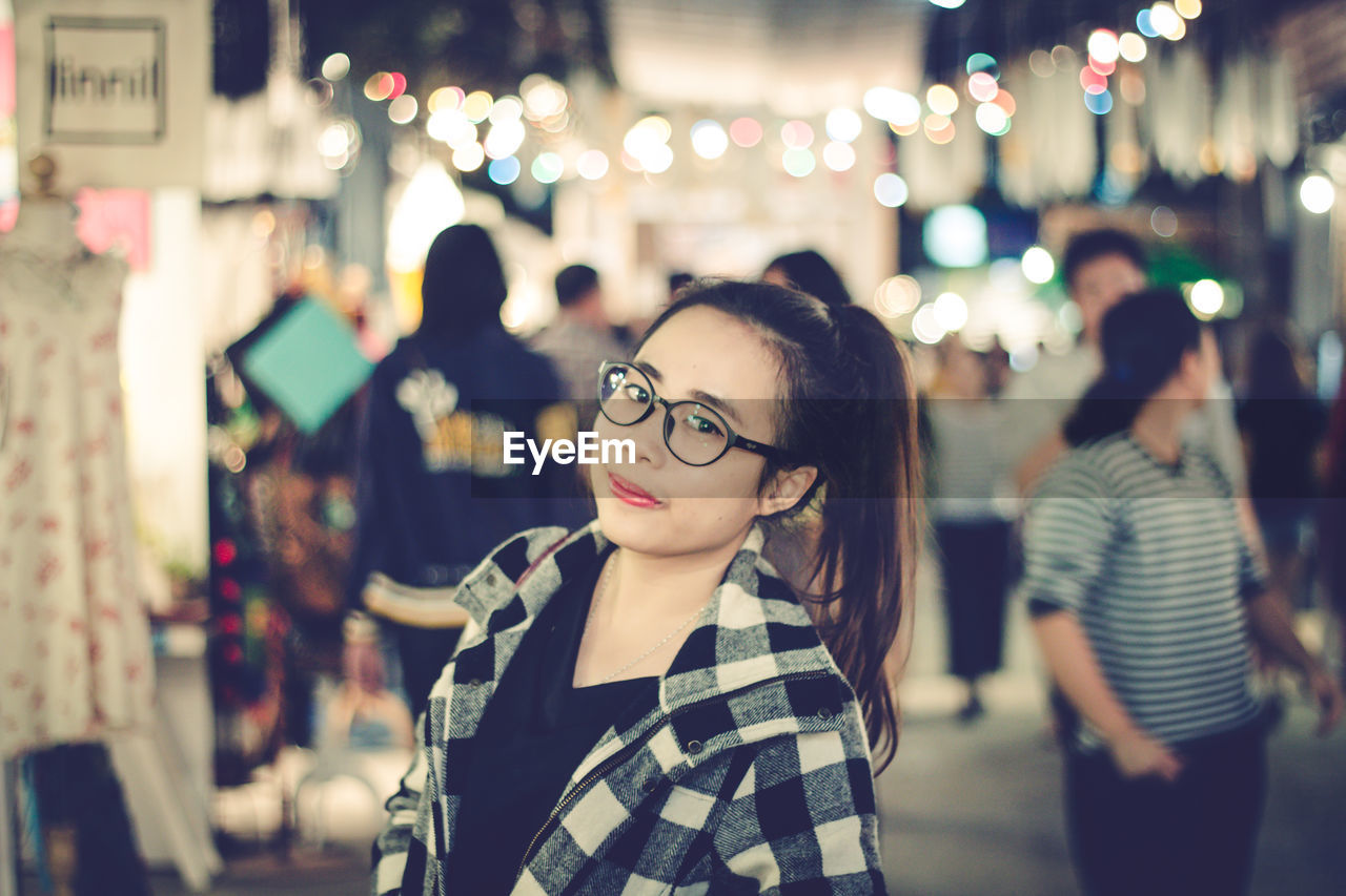 Portrait of young woman in city