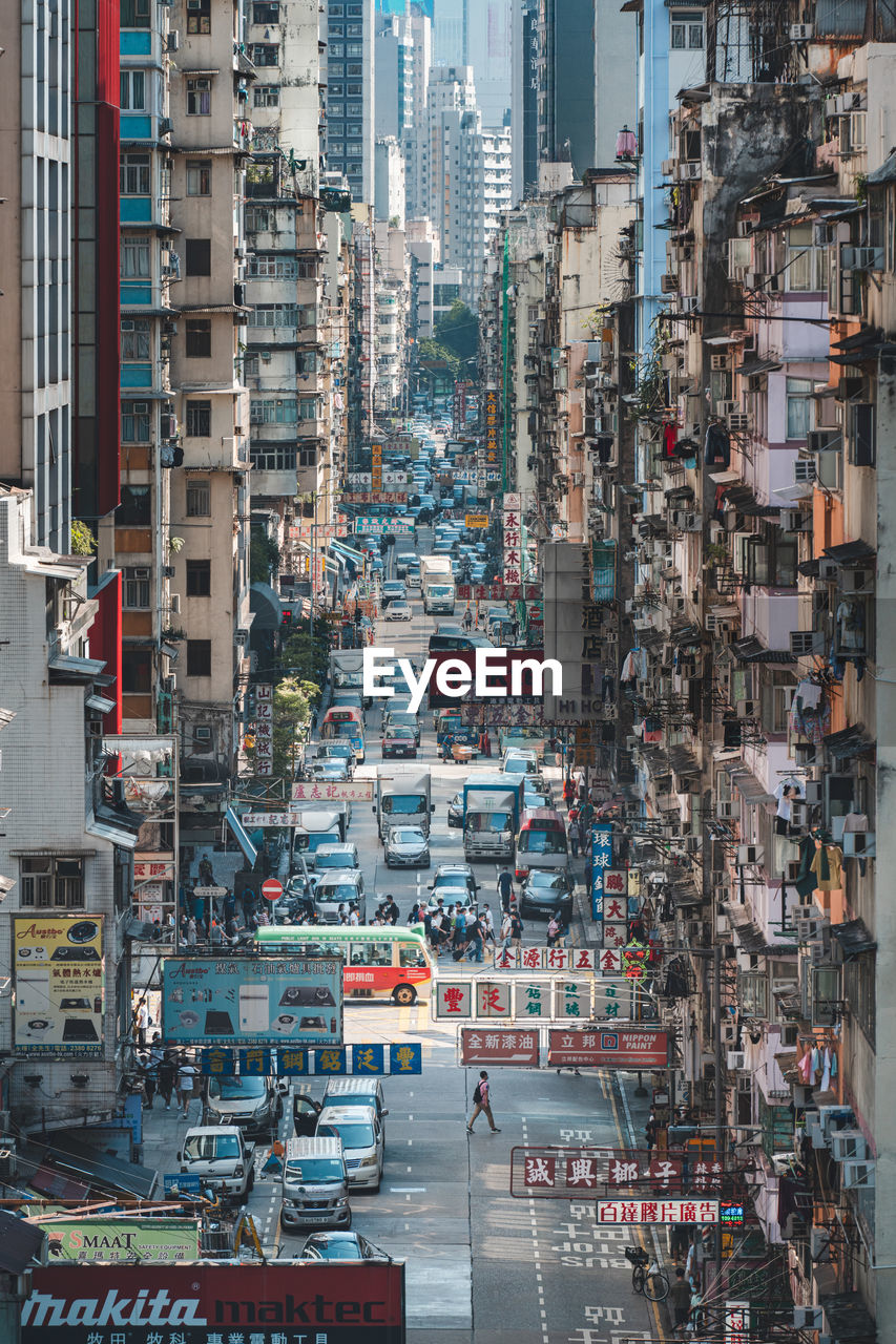 HIGH ANGLE VIEW OF CITY STREET AMIDST BUILDINGS