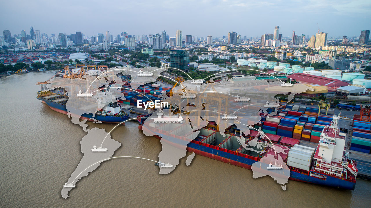 High angle view of buildings by sea against sky