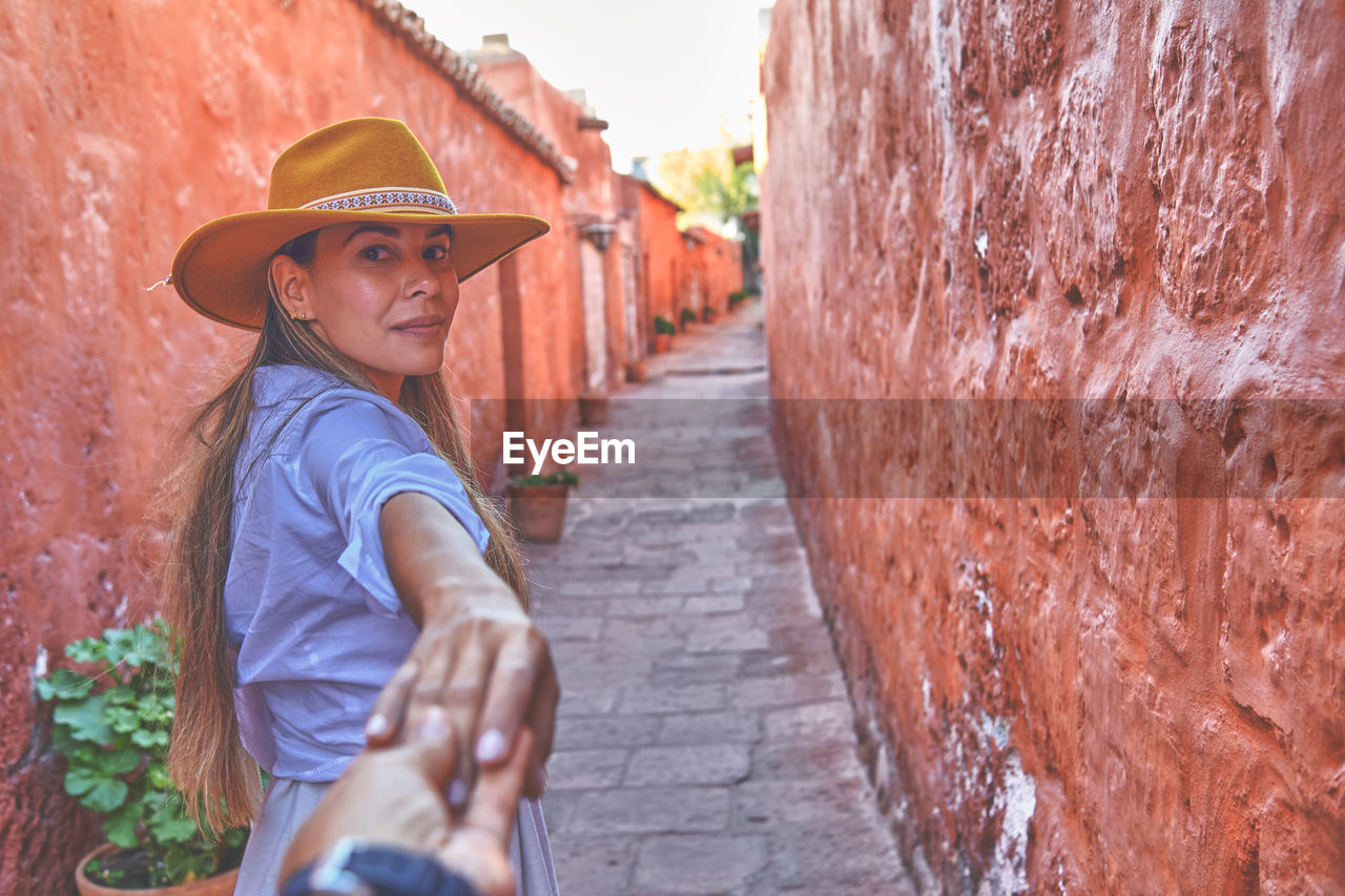 Couple holding hands in santa catalina monastery, convento de santa catalina, arequipa, peru. 