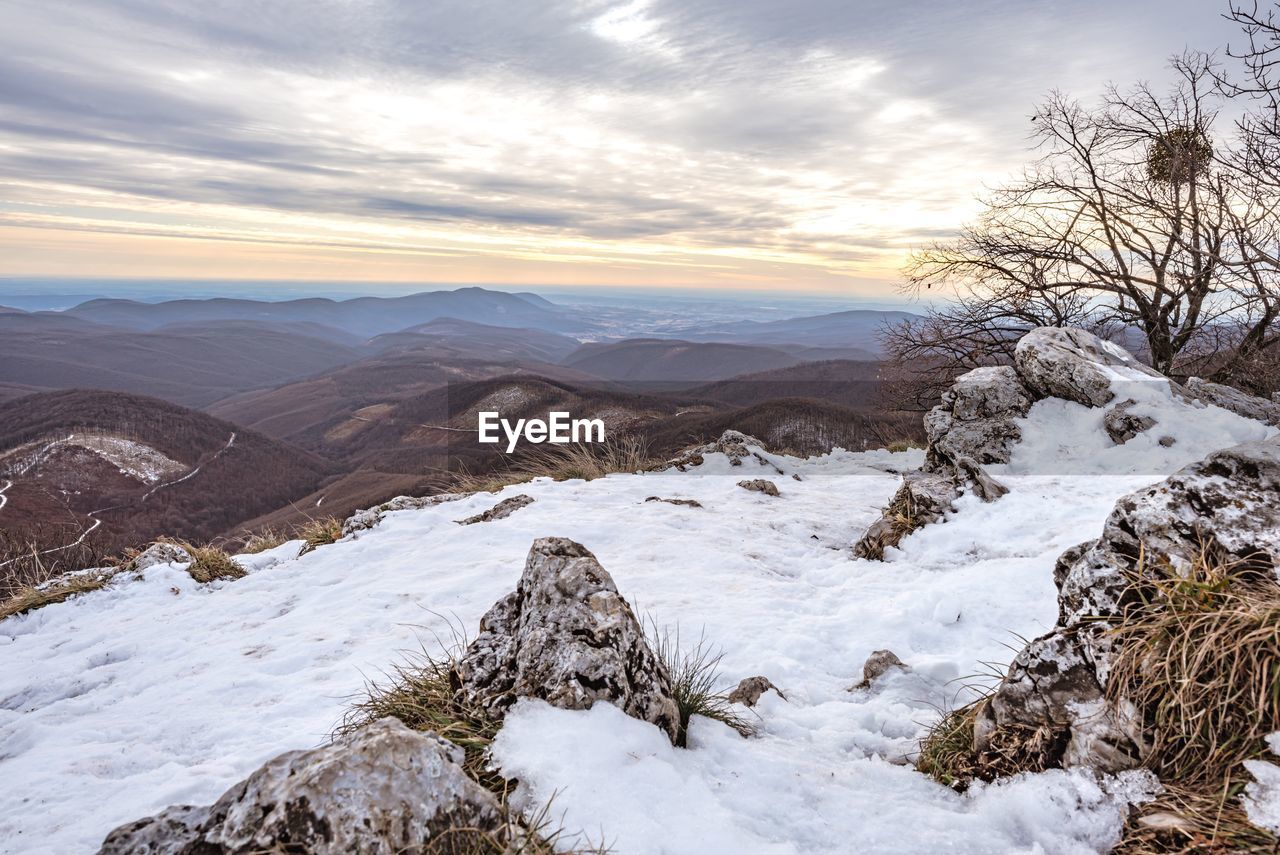 Scenic view of snowcapped mountains against sky during sunset