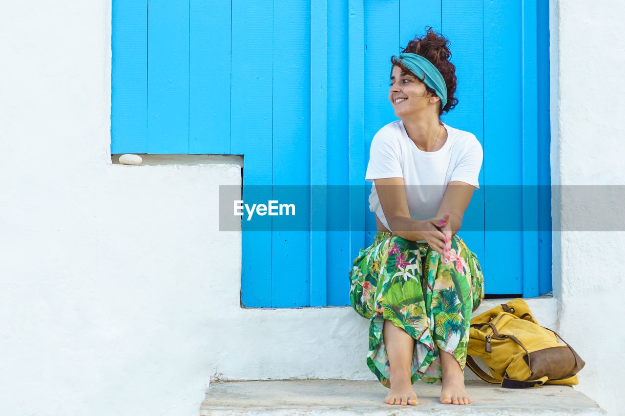 Isolated woman with backpack on holidays in europe. woman on stairs on spanish travel destination.