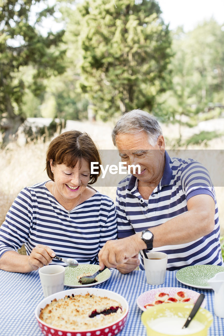 Mature couple having meal outdoor