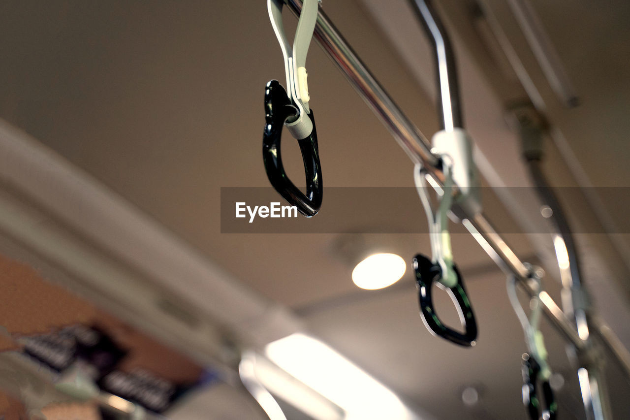 Low angle view of lighting equipment hanging on ceiling