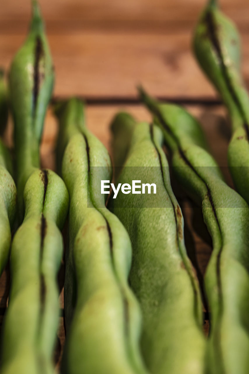 Close up of green beans on wooden table