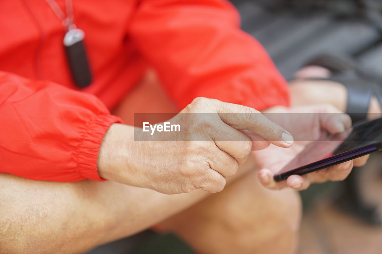 Old elder senior man elderly male using mobile smart phone cellphone outdoor. mature retirement 